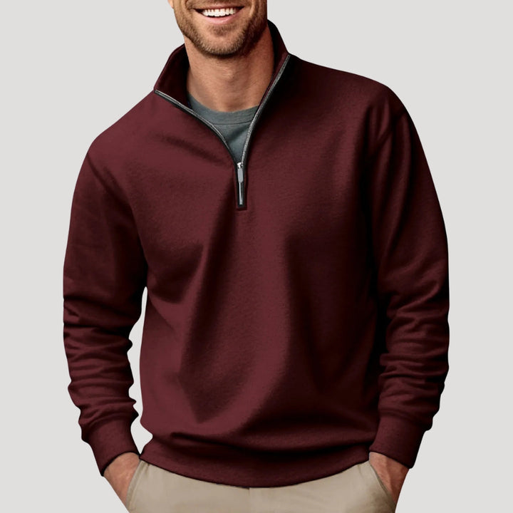 Burgundy men's quarter-zip sweatshirt with a funnel neck, relaxed fit, and soft fabric worn over a grey t-shirt.