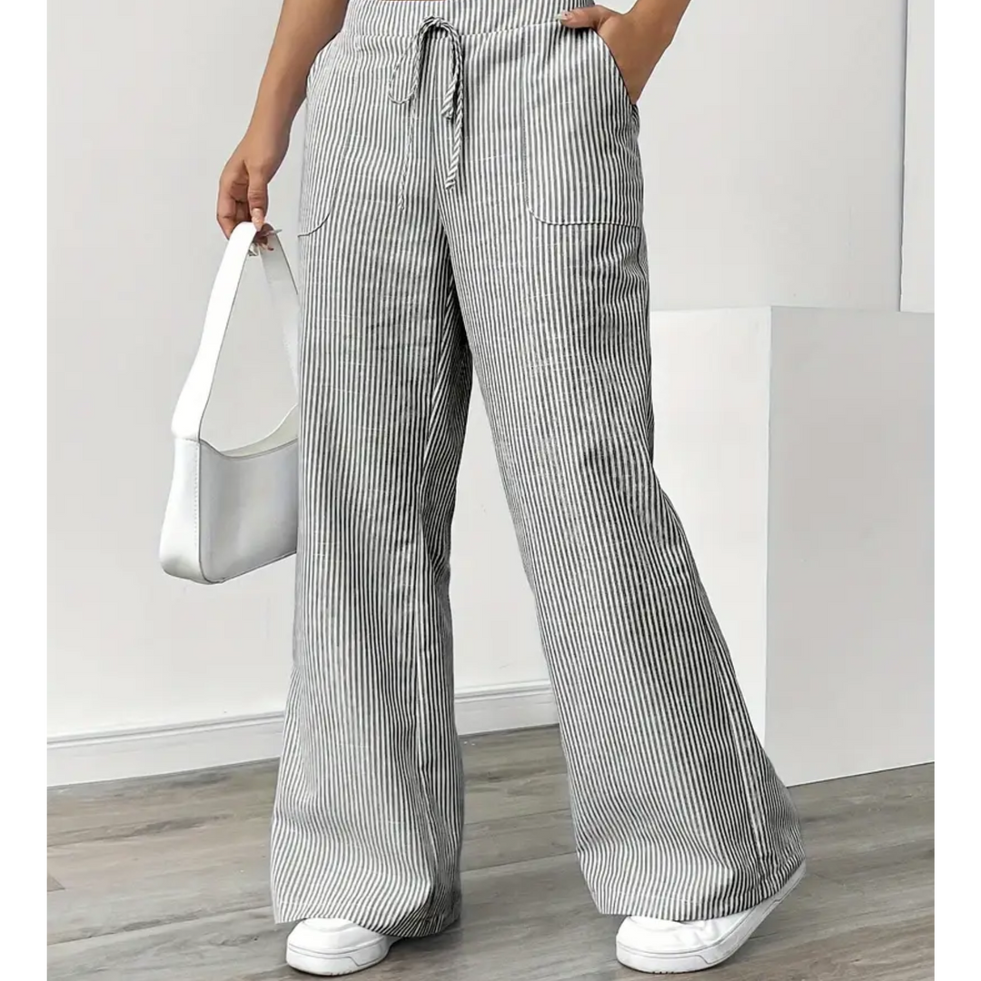 Women's grey and white striped linen wide-leg trousers with a drawstring waist and side pockets.