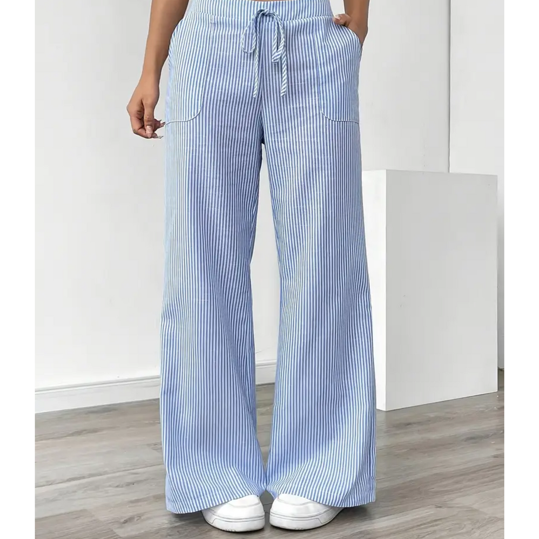 Amelia wide-leg linen trousers in blue and white vertical stripes with a drawstring waist and front pockets.