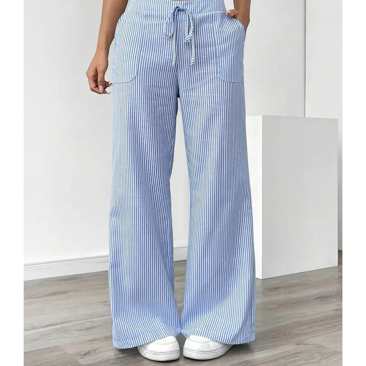 Amelia wide-leg linen trousers in blue and white vertical stripes with a drawstring waist and front pockets.