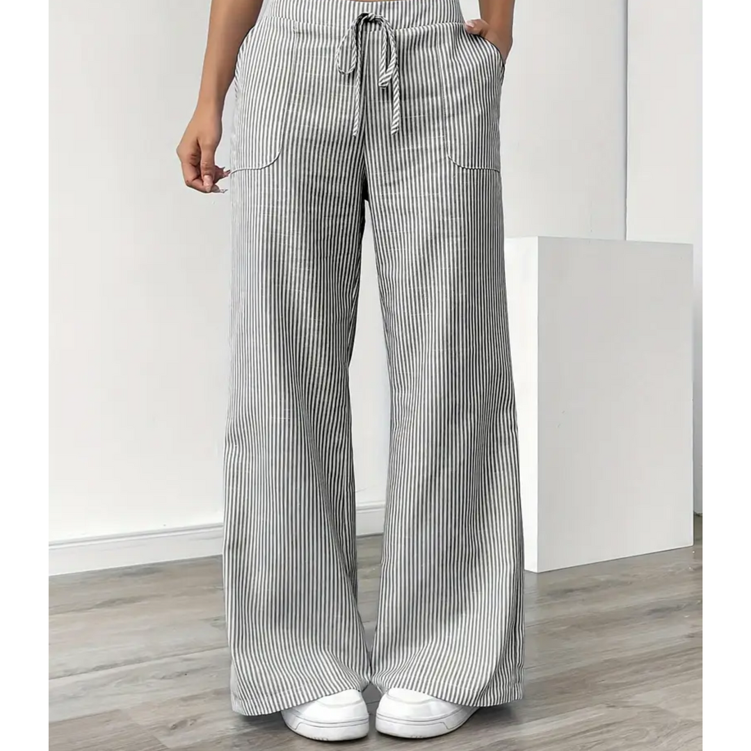 Amelia wide-leg linen trousers in grey and white vertical stripes with a drawstring waist and side pockets.