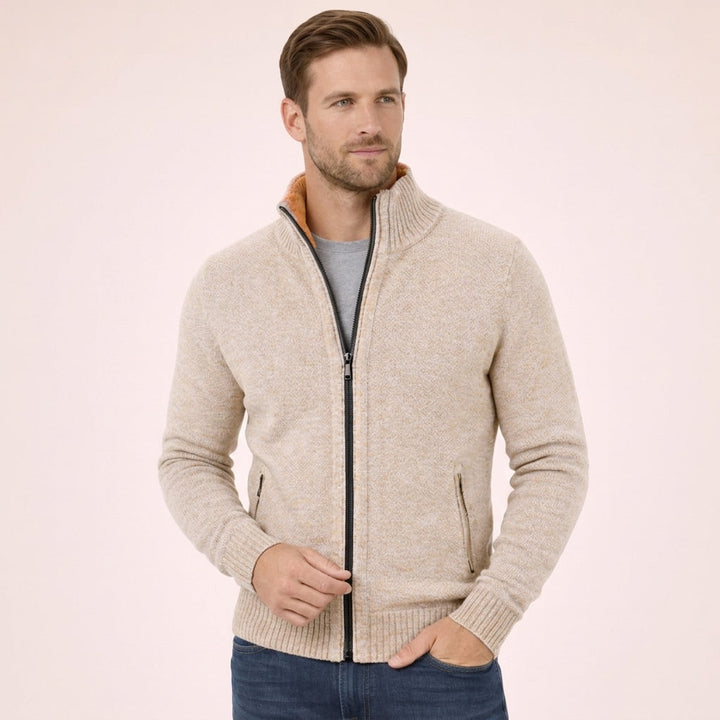Beige merino wool full-zip jumper with a ribbed funnel collar, marled knit texture, and practical side zip pockets.