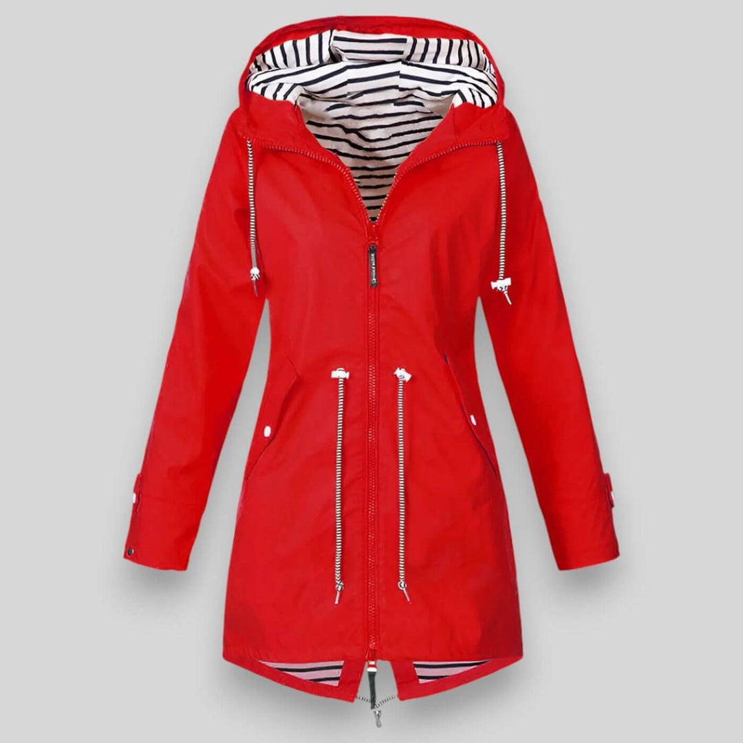 Red waterproof longline raincoat with an adjustable hood, drawcord waist, and nautical striped lining.