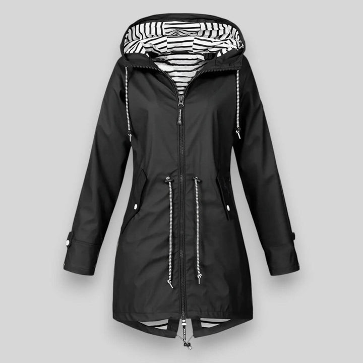 Black waterproof longline raincoat with an adjustable hood, drawcord waist, and nautical striped lining.