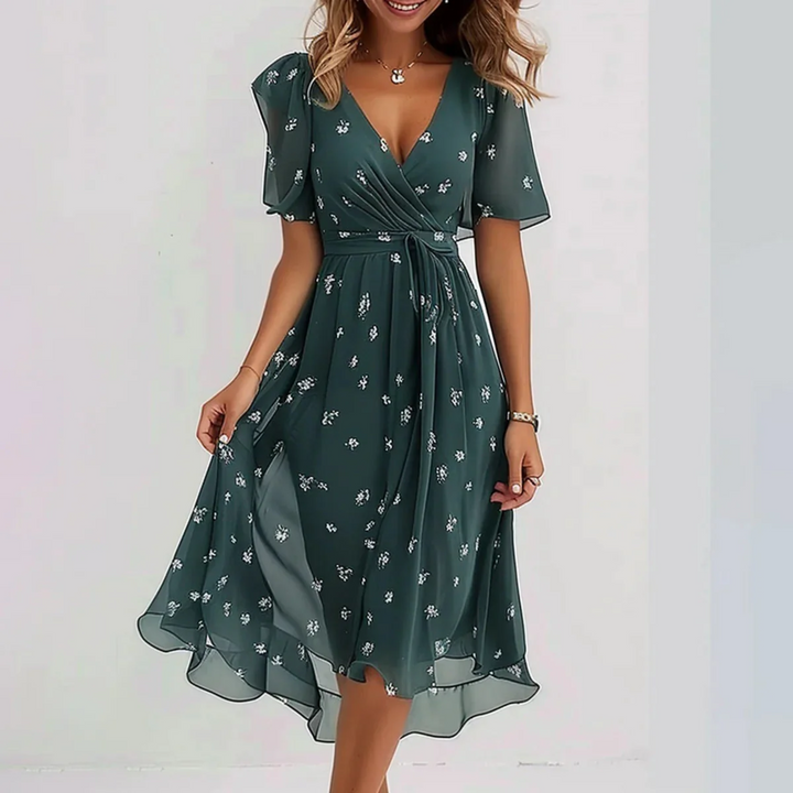 Beatrice women's flowy summer dress in dark green with white floral print, V-neck, and tie waist.
