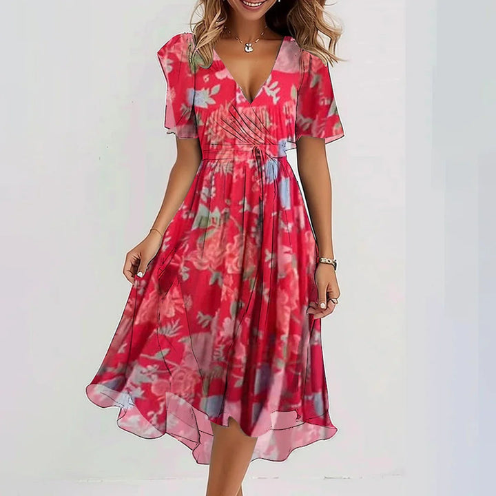 Beatrice red floral flowy summer dress with V-neck, short sleeves, and a flattering silhouette.