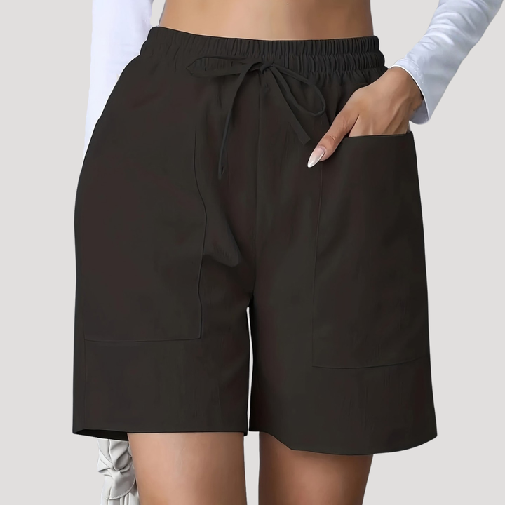 Black wide-leg shorts with an elastic drawstring waist and deep front patch pockets.