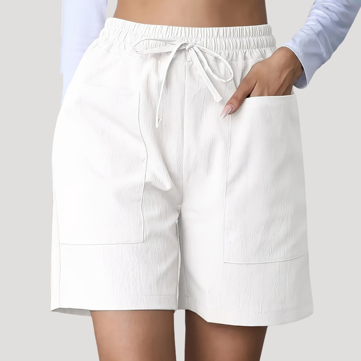 White wide-leg shorts with an elastic drawstring waist and deep front patch pockets.