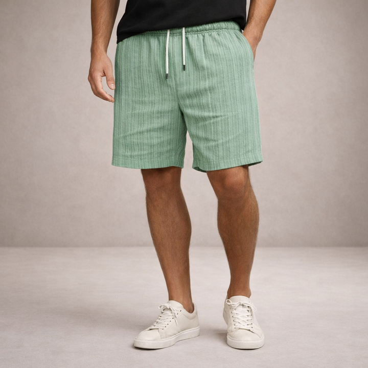 Sage green men's linen-look shorts featuring an elasticated drawstring waist and a relaxed, straight-leg fit.