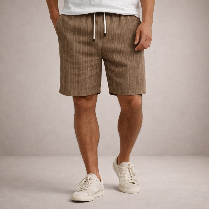 Men wearing brown linen-look drawstring shorts with a straight hem and side pockets, paired with white sneakers.