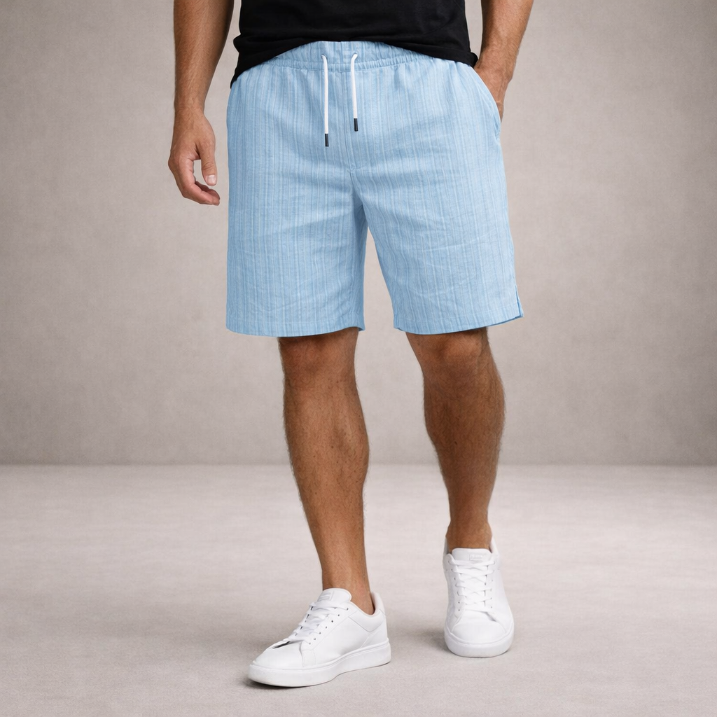 Light blue striped linen-blend shorts with an elasticated drawstring waist and side pockets worn with white sneakers.