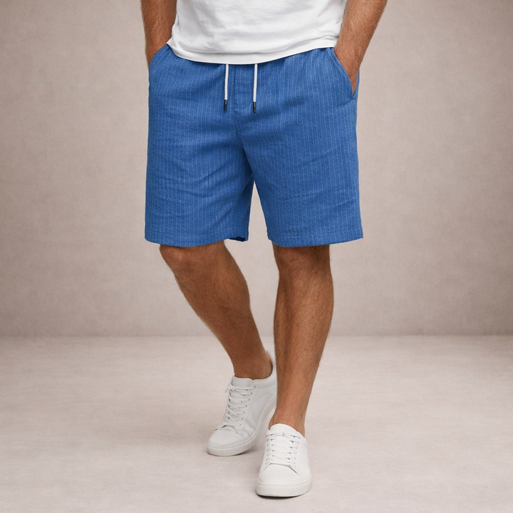 Blue striped linen-look drawstring shorts with an elasticated waist and side pockets worn with white sneakers.