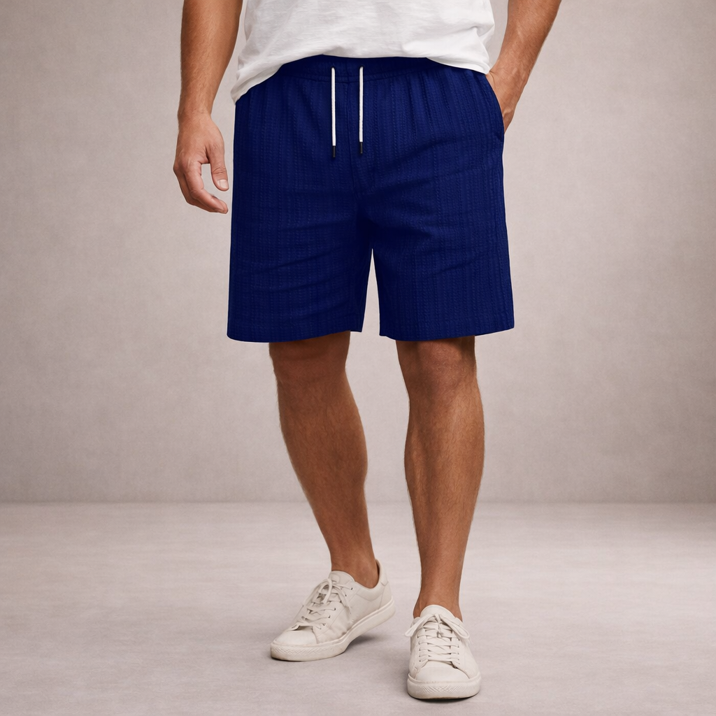 Men wearing navy blue linen-look drawstring shorts with an elasticated waist and side pockets.