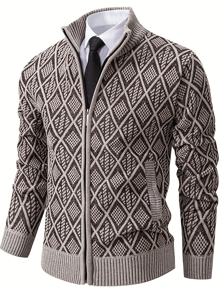 Brown and beige geometric rhombus knit zip-up cardigan with a stand collar and ribbed cuffs worn over a shirt and tie.