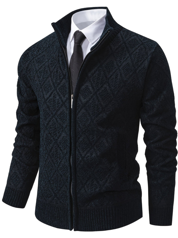 Men's navy blue zip-up cardigan featuring a geometric diamond knit pattern, stand collar, and ribbed trim over a shirt.