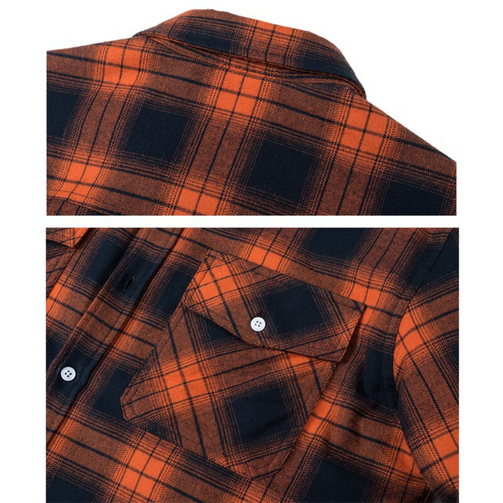Close-up of an orange and black plaid shirt jacket featuring a classic collar, button-down front, and flap chest pocket.