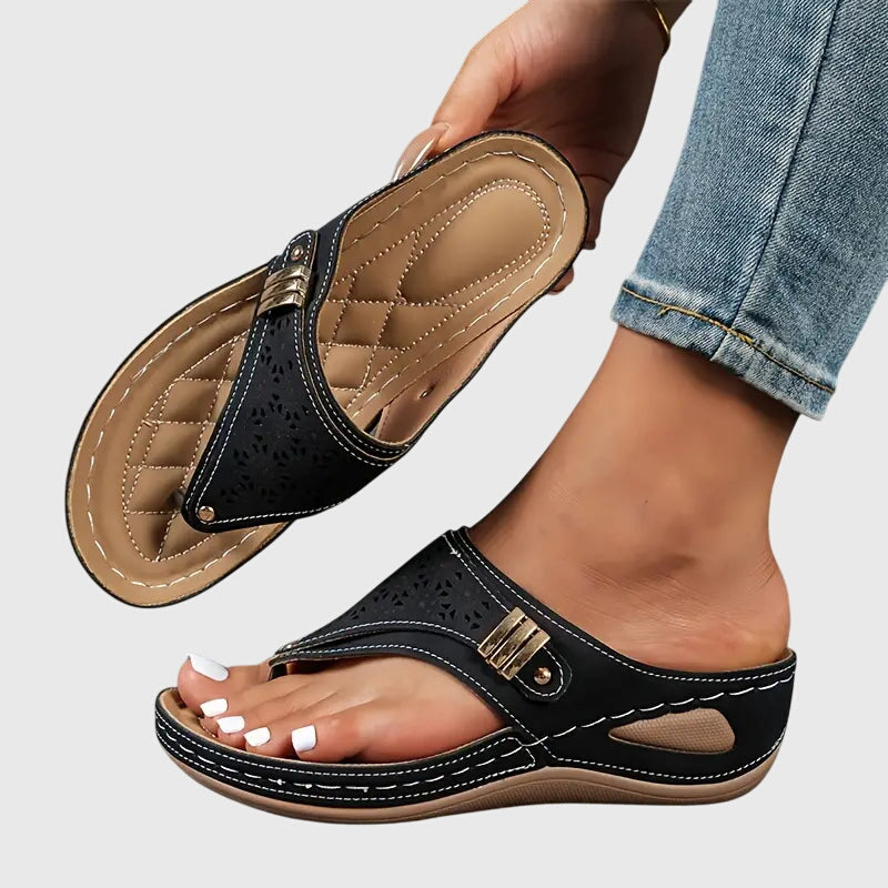 Bonnie black orthopedic wedge sandals with perforated straps, gold buckle, and supportive footbed.