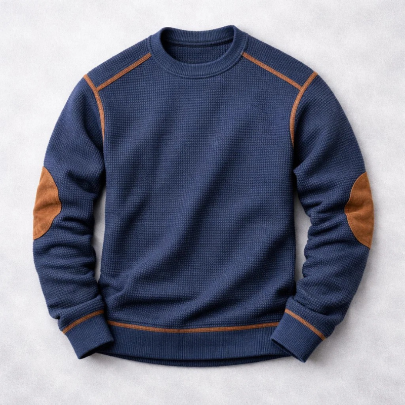 Navy blue waffle-knit crew neck jumper with brown suede elbow patches and matching trim details.