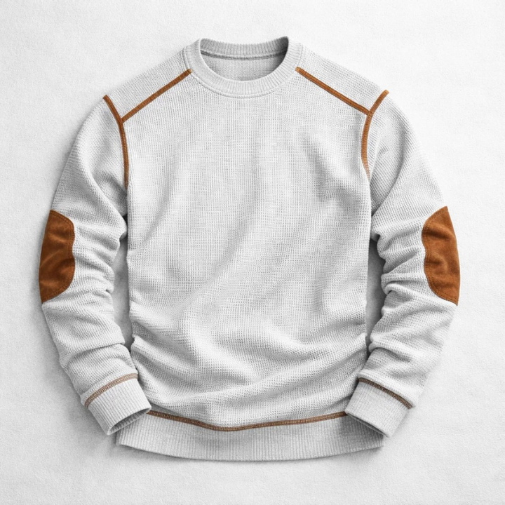 Light grey waffle-knit crew neck jumper with brown contrast elbow patches and shoulder detailing.
