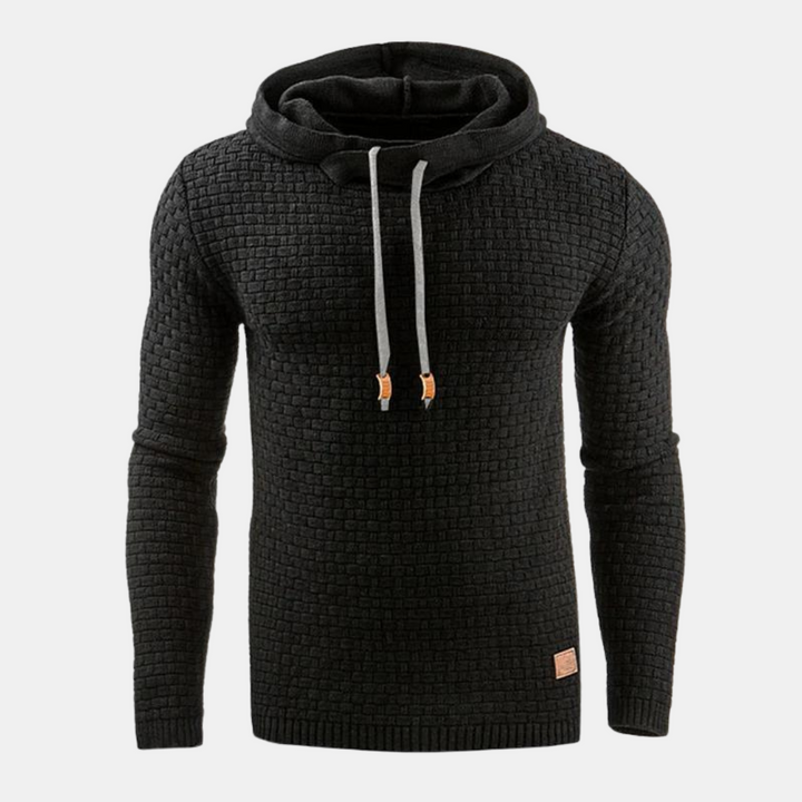 Black men's textured waffle-knit hoodie with an attached hood, grey drawcords, and ribbed cuffs.