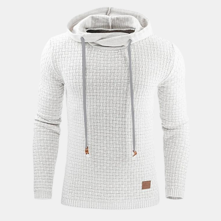 Off-white men's textured waffle-knit hoodie with a drawstring hood, ribbed cuffs, and a small leather hem patch.
