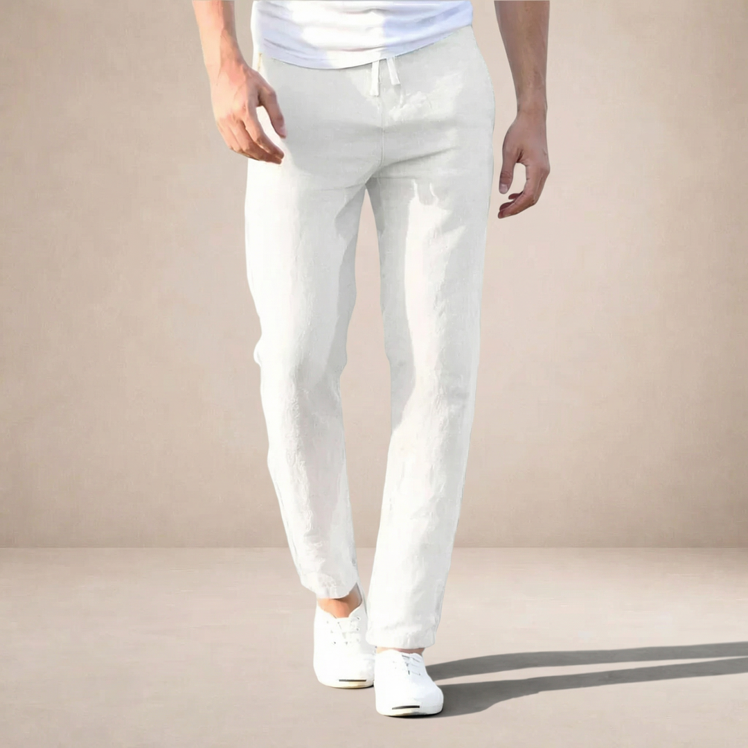 Men wearing white straight-leg linen trousers with a drawstring waist and side pockets, paired with white trainers.