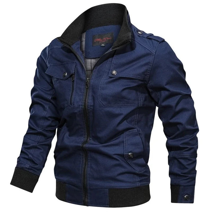 Navy blue military field jacket with ribbed stand collar, full zip, chest pockets, and shoulder epaulettes.