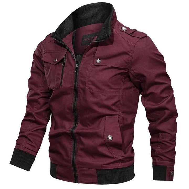 Burgundy men's military field jacket with a black ribbed stand collar, full front zip, epaulettes, and multiple utility pockets.
