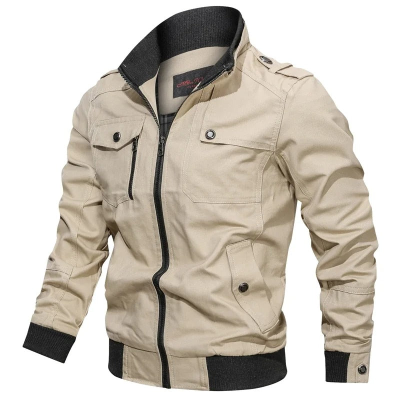 Beige military-style field jacket with a black ribbed stand collar, full zip front, epaulettes, and multiple utility pockets.