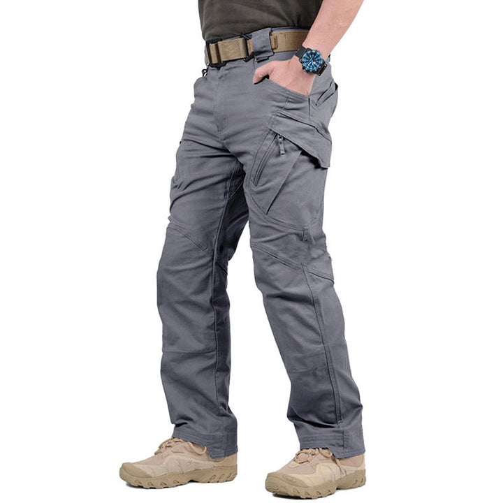 Grey men's tactical cargo trousers featuring reinforced stitching, multiple secure zip pockets, and a durable outdoor fit.