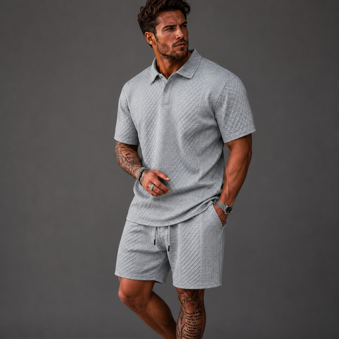 Man wearing a light grey textured short-sleeve polo shirt and matching drawstring shorts set.