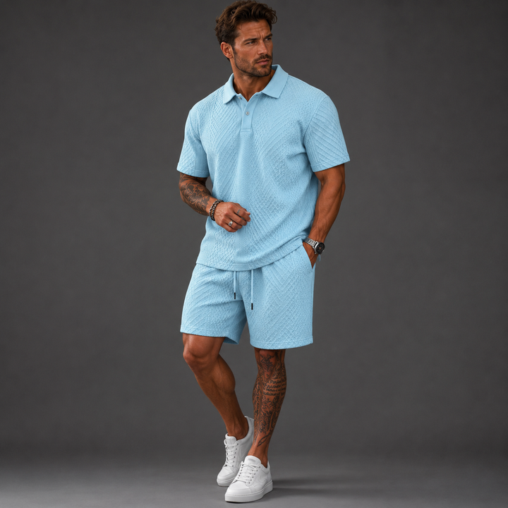 Man wearing a light blue textured short-sleeve polo shirt and matching drawstring shorts set.