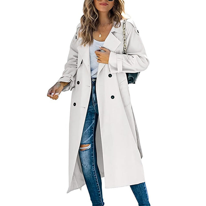 Elegant cream long-line trench coat with a double-breasted button front and notched lapels for a timeless layered look.
