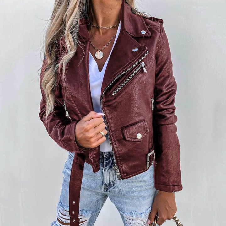 Burgundy faux leather biker jacket with asymmetric zip, notched lapels, and adjustable waist belt.