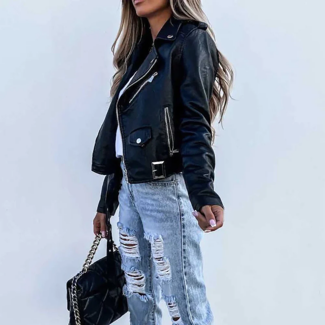 Black cropped faux leather biker jacket with asymmetric zip, notched lapels, and adjustable waist belt.
