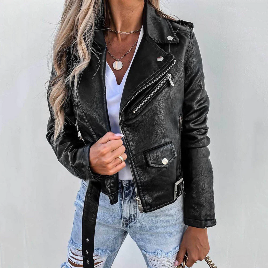 Black faux leather biker jacket with asymmetric zip, notched lapels, silver hardware, and an adjustable waist belt.
