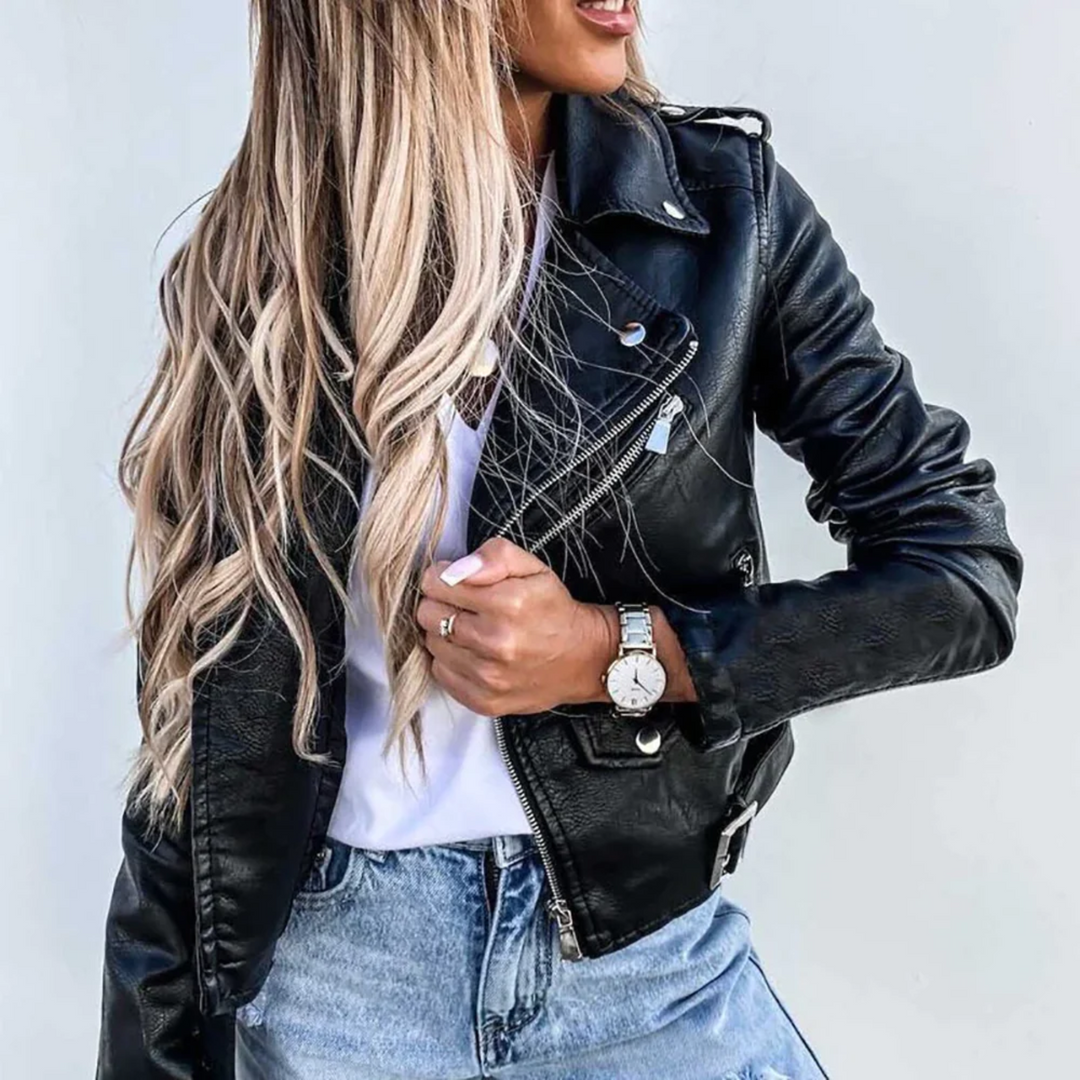 Black faux leather biker jacket with asymmetric zip, notched lapels, and adjustable waist belt over a white tee.