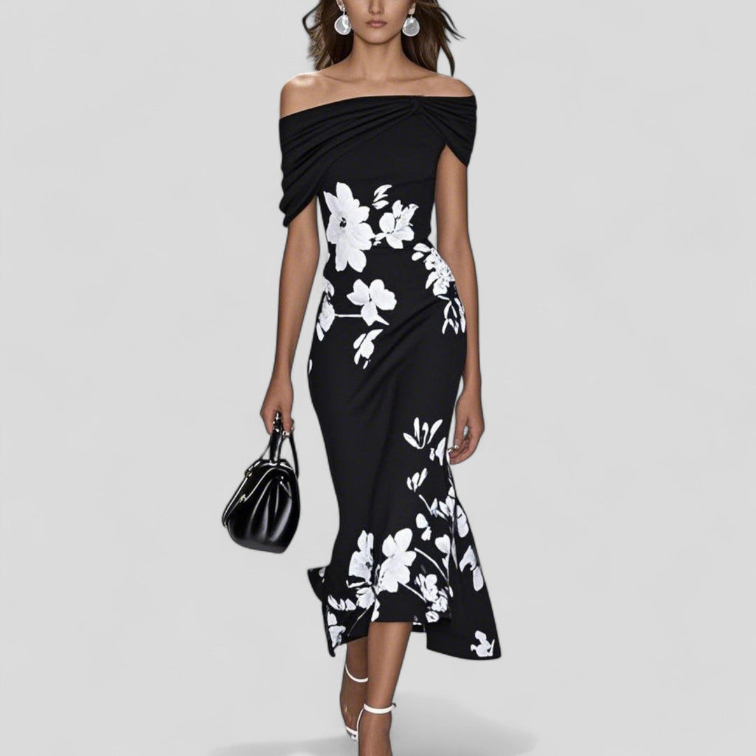 Charlotte Women's Floral Printed Midi Dress: Black off-shoulder midi dress with white floral print, carrying a black handbag.