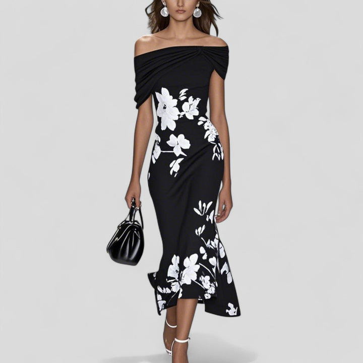 Charlotte Women's Floral Printed Midi Dress: Black off-shoulder midi dress with white floral print, carrying a black handbag.