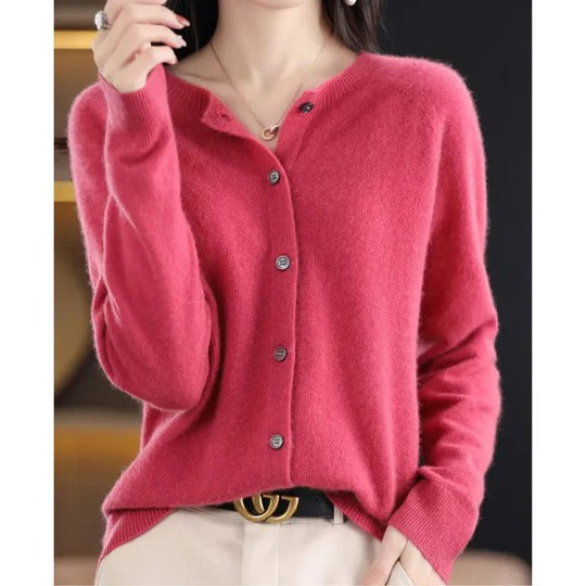 Soft pink fine-knit cardigan featuring a round neckline, long sleeves, and a polished front button-up closure.