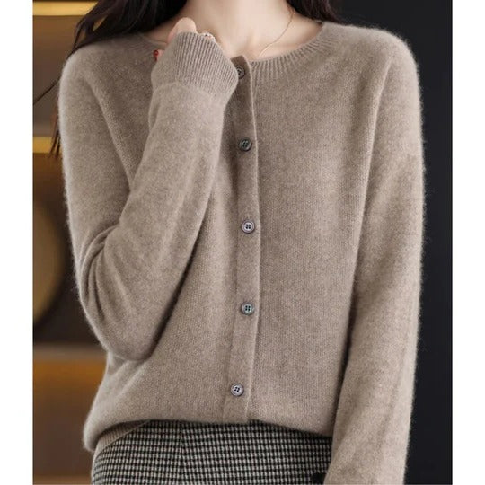 Soft beige round-neck cardigan in a fine knit with a polished button-up front and ribbed cuffs for a refined, cozy fit.