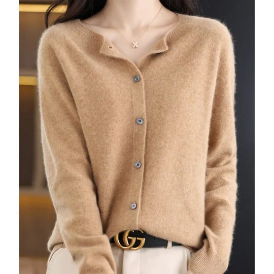 Soft beige round-neck cardigan in a fine knit with a polished button-up front and comfortable ribbed cuffs.