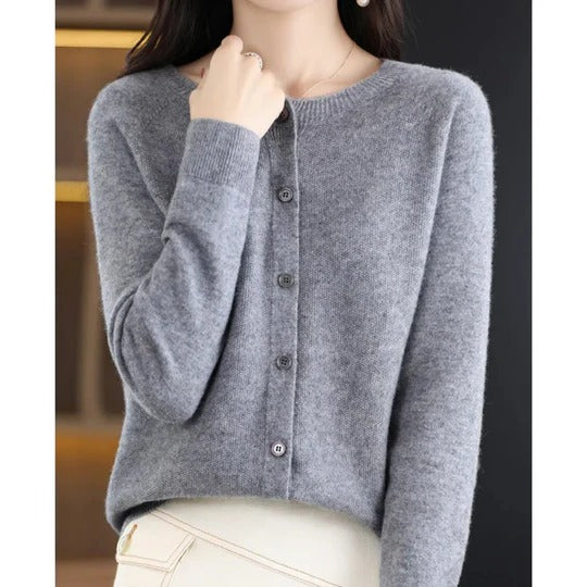Soft grey round neck button-up cardigan in a fine knit with ribbed cuffs for a polished, feminine layered look.