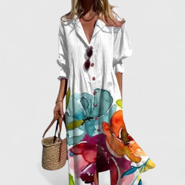 Cora white boho maxi dress with vibrant floral print, short sleeves, and relaxed drape.