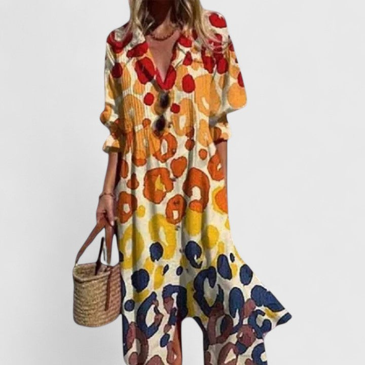 Cora women's boho maxi dress with bold, colorful animal print, short sleeves, and flowing silhouette.