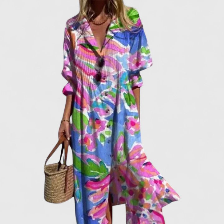 Cora women's boho maxi dress with bold, colorful floral print, short sleeves, and flowing silhouette.