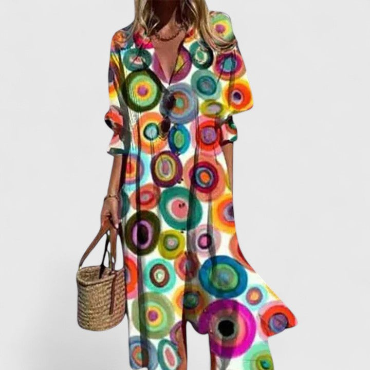 Women's Cora boho maxi dress with vibrant, multi-colored circle print, V-neck, and short sleeves.