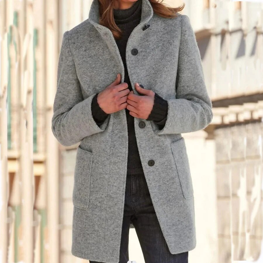 Grey wool-blend longline coat featuring a sophisticated funnel collar, button-front closure, and practical front pockets.