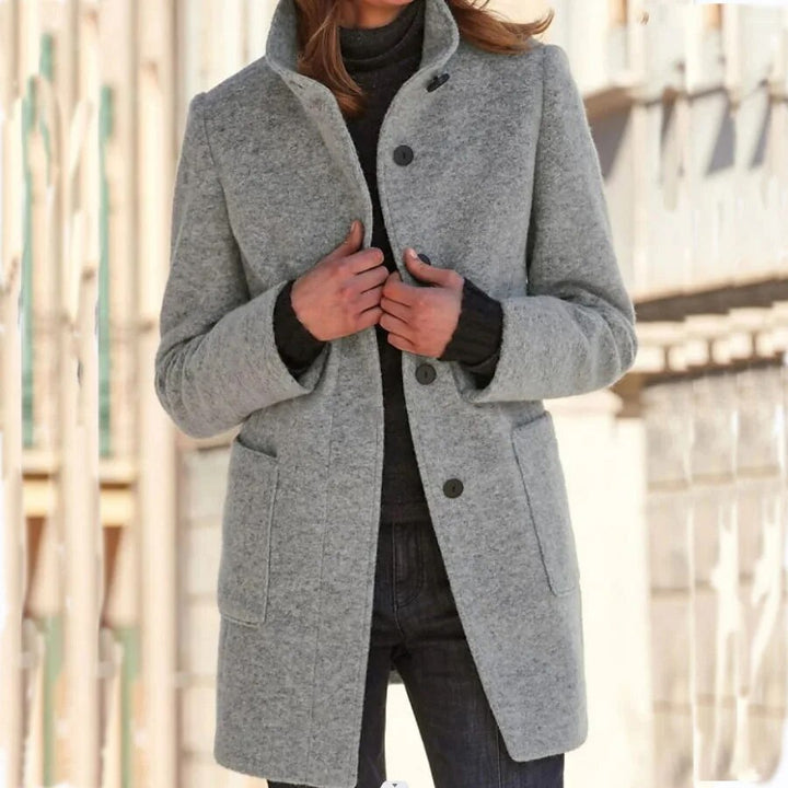 Grey wool-blend longline coat featuring a sophisticated funnel collar, button-front closure, and practical front pockets.