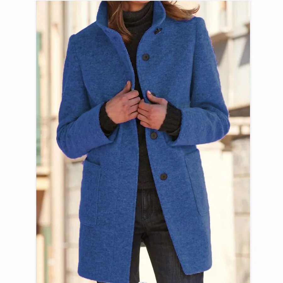 Blue longline wool-blend coat featuring a standing funnel collar, button-front closure, and practical front pockets.